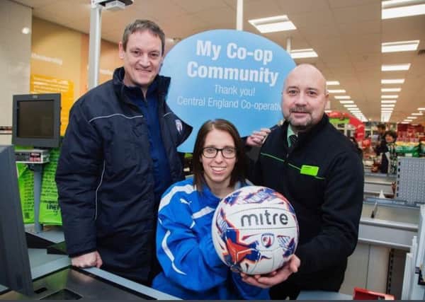 First team manager Steve Barber and captain Samantha Stokes visit the Co-op to say thank you