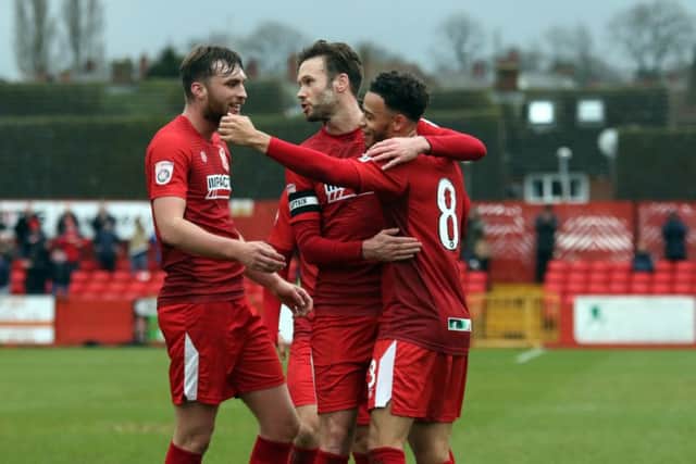 Tom Allan and Andy Monkhouse congratulate the scorer of Alfreton's second goal, Wes Atkinson.
Photo: Eric Gregory
