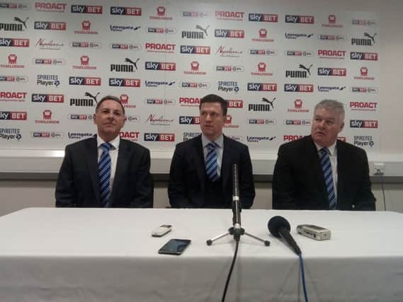 Chesterfield's new boss Gary Caldwell, centre, flanked by company director Ashley Carson, left, and Chris Turner, right