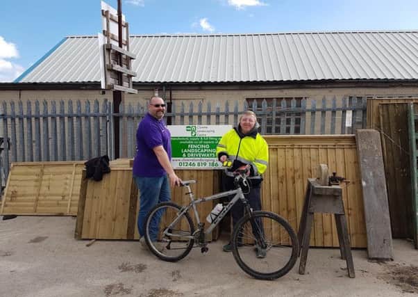 Russell Swallow of Clowne Landscape, presenting new bike to Richard Eckersall, who had his old one stolen.
