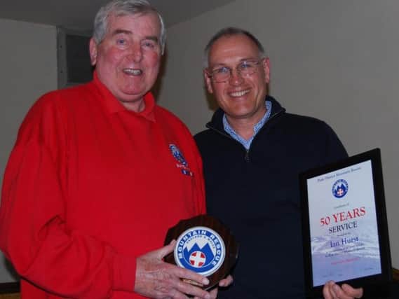 Ian (left) receiving his Fifty Years Long Service Awards from P.D.M.R.O. President, David Coleman, in 2013. Photo- Buxton Mountain Rescue Team.