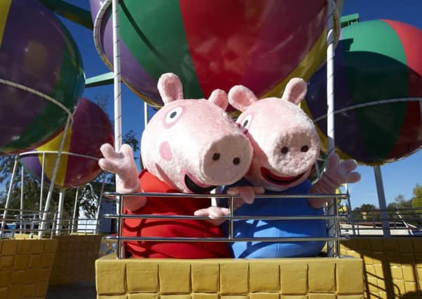 Peppa and George enjoy Peppa's Big Ballon Ride at Peppa Pig World, part of Paultons Family Theme Park in Hampshire.