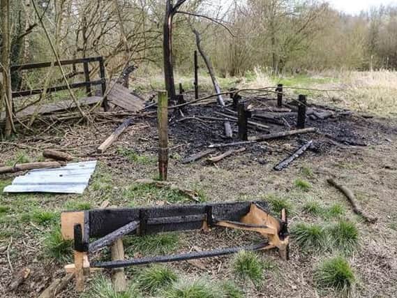 The scene after fire destroyed the hide in Mapperley Wood on Saturday.