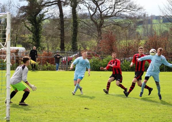 Lee Clay heads the crucial opening goal for Clay Cross Town in their 3-0 win over Dronfield Town Reserves.