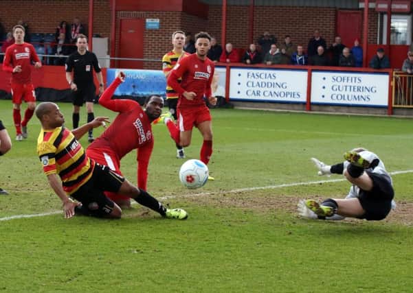 Defender Matt Hill slides in to block Craig Westcarrs follow up after he missed the penalty.