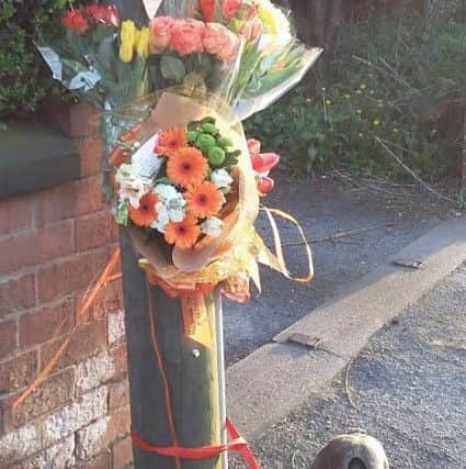 Marks dog with the floral tributes.
