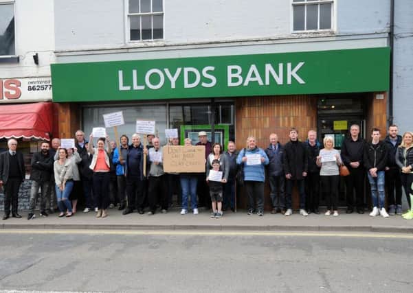 Locals gather to show their disapproval of Lloyds Bank's decision to close it's Clay Cross branch on High Street.