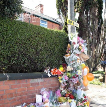 Floral tributes at the roadside.