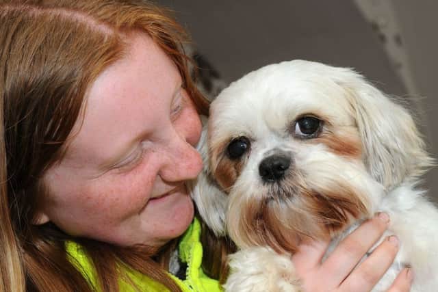 Rebecca Lucas, 17, is reunited with her Shih Tzu dog, Honey.