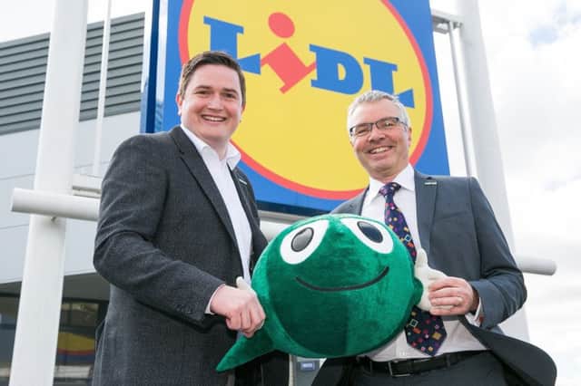 Lidl UK's CEO Christian Hartnagel and NSPCC's CEO Peter Wanless with the NSPCC mascot 'Buddy' at the Wimbledon Lidl Supermarket in Wimbledon, South London.