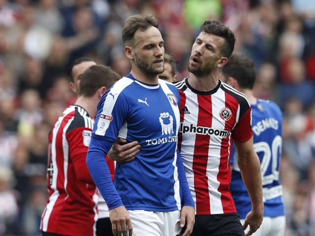 Jake Wright of Sheffield Utd  walks Dan Gardner of Chesterfield after his sending off during the English League One match at  Bramall Lane Stadium, Sheffield. Picture date: April 30th 2017. Pic credit should read: Simon Bellis/Sportimage