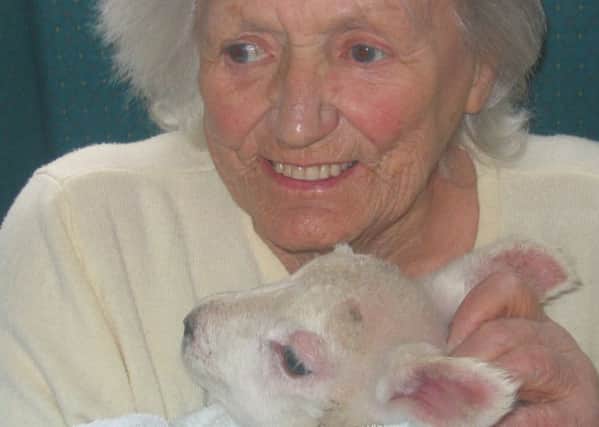 Patient Mavis Yates with a lamb.