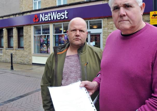Keith Bannister, right, the owner of Tillys Bar and Harley's Bar in Staveley and Tony Kay from Kay's Carpets with a 600 name petition against the closure of the town's NatWest branch.