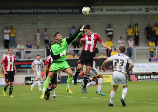 Joe Anyon, pictured as a Burton trialist, challenges his new team-mate Conor Dimaio in a  fixture with Sheffield United