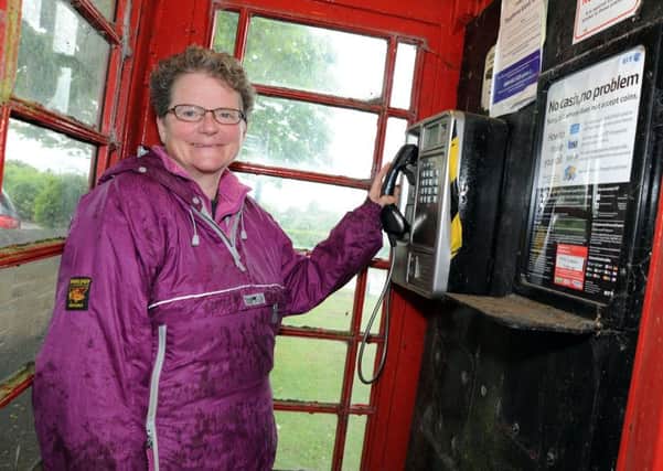 Christine Gare and the Marsh Lane telephone box which is staying put.