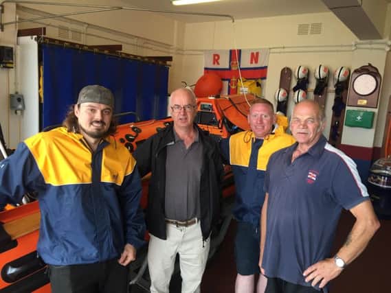 Bob Hitchcock with Withernsea RNLI crewmen Luke Newton and Daniel Lythe who were part of the crew that launched, and Deputy Launch Authority John Hartland. Photo - RNLI/Withernsea