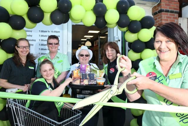 The ribbon is cut following a major revamp of the store on Alfreton Road, Little Eaton.