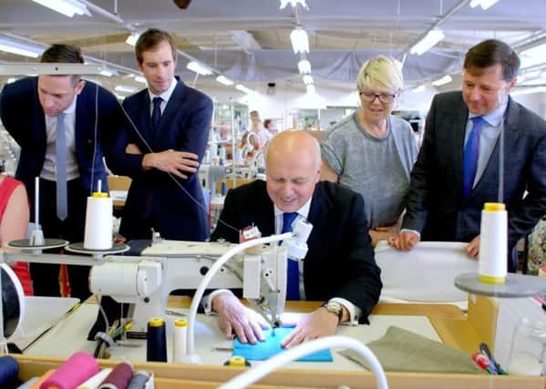 Iain Duncan Smith tried his hand on a sewing machine during the visit.