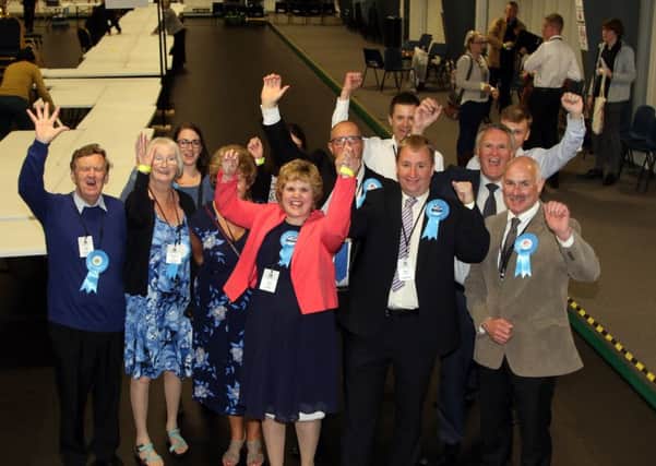 Nigel Mills and his supporters celebrate victory.
