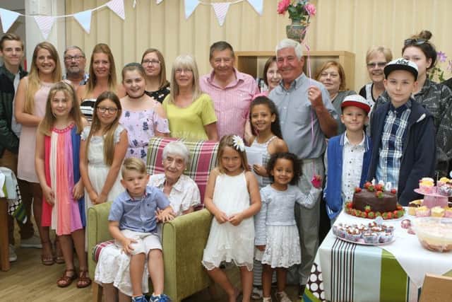 Florence Dodd surrounded by her family on her 100th birthday.