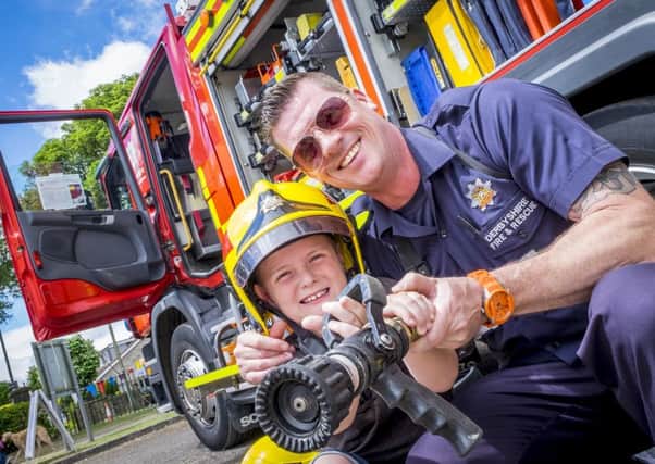 Bolsover Gala 2017 Ashley Dickinson aged 8 with fire fighter from Bolsover station Robb Harris