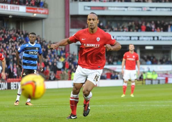 Chris O'Grady takes a penalty for Barnsley, watched by Scott Wiseman in the background. Picture by Simon Hulme