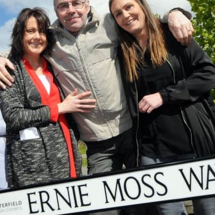Ernie Moss with his daughters, Nikki Trueman, left, and Sarah Moss at the unveiling of his street sign.