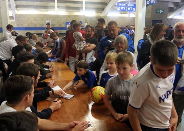 A young fan gets an autograph.