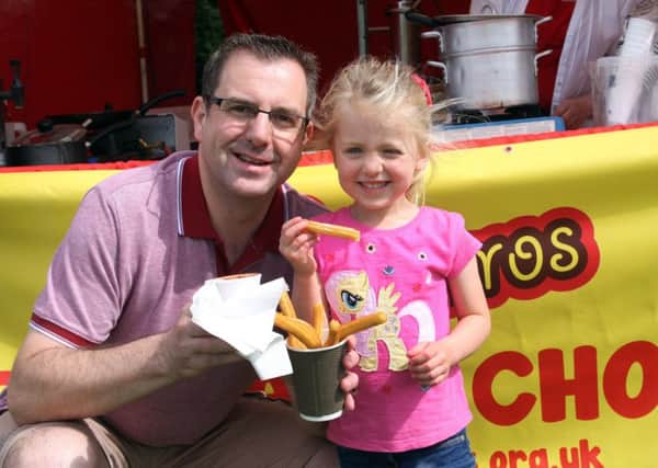 Dad Lee Richards bought a cone of Churros for daughter Scarlott.