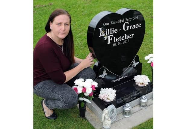 Lisa Fletcher at the grave of her baby girl, Lillie-Grace, in Killamarsh Cemetery.