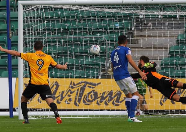 Spireites keeper Tommy Lee is beaten by Frank Nouble's header for Newport's second goal