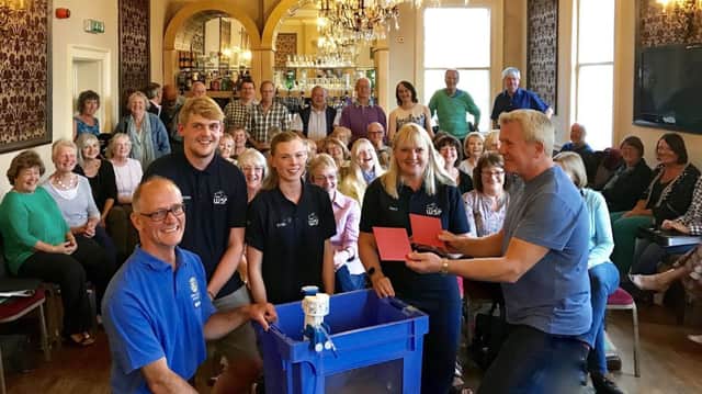 Lester Simpson, leader of Raise Youir Voices, presents cheques to Roger Cassidy, representing Aquabox,  and Fleur Fern of Wirksworth Swimming Pool.