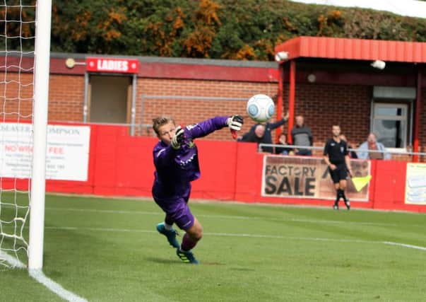 A desperate dive by Gainsborough keeper Henrich Ravas cant stop Brendon Daniels free kick from giving Alfreton a 4 goal lead.