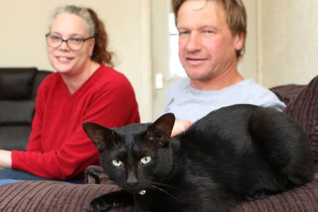 Beetle the cat with owner Sandra Allen and rescuer Gary Barson
