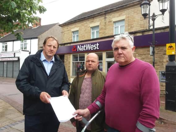 Mr Perkins with Keith Bannister, right, the owner of Tilly's Tavern and Harley's Bar in Staveley, and Tony Kay, from Kay's Carpets in the town, with a 900-name petition against the closure of NatWest.