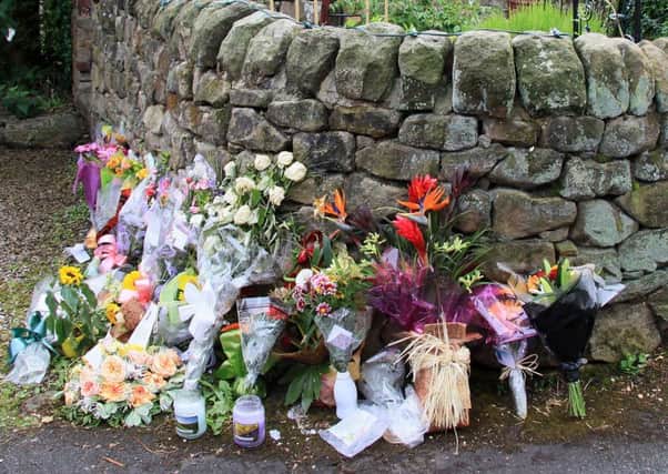 Flowers left at house of the Holbrook stabbings in 2010.