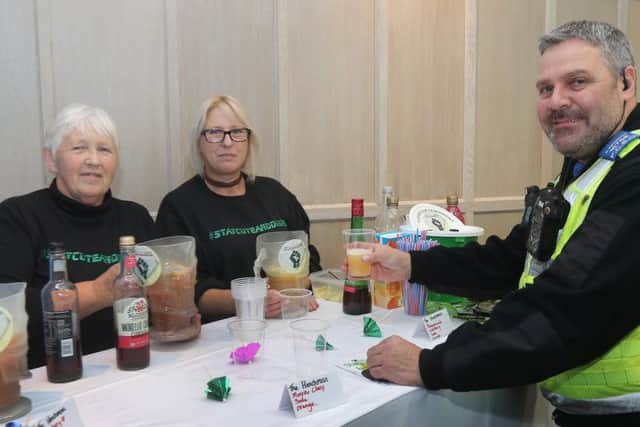 Yvonne Henchliffe and Fay Wainwright serve up a mocktail for PCSO Brian Pemberton. Picture by Jason Chadwick.