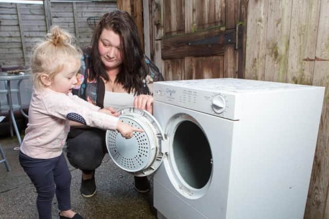 Iiylah-Louise was dragged inside the tumble dryer after opening the door of the dryer and getting her finger caught on a blanket as it sped round the drum. Photo - SWNS