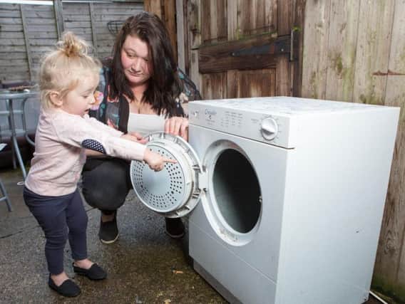 Iiylah-Louise was dragged inside the tumble dryer after opening the door of the dryer and getting her finger caught on a blanket as it sped round the drum. Photo - SWNS