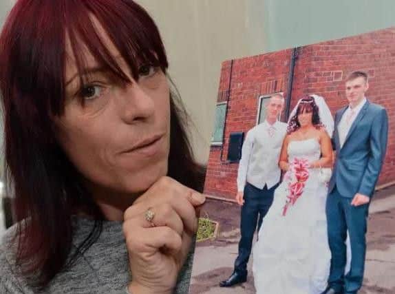 Sharon Whitford holding a picture of her son Marc Maltby (in the white top) who was sadly found dead in Nottingham prison. Picture by Brian Eyre.
