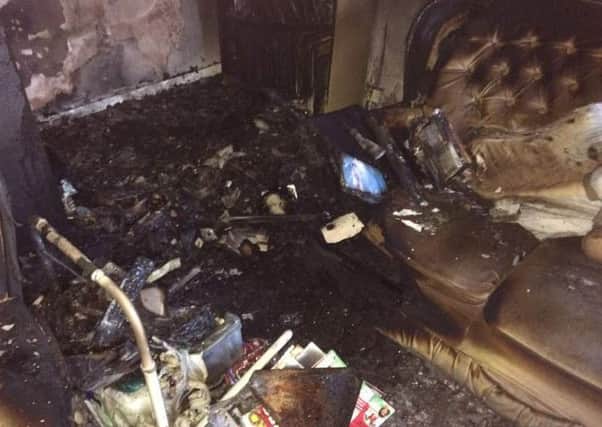 Living room of a Tibshelf house damaged after fireworks posted through letterbox. Pictures from BBC.