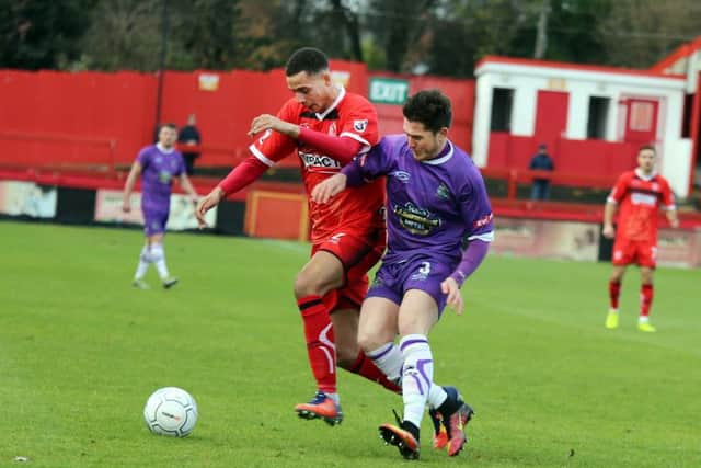 Alfreton's Marcus Marshall battles with Connor Hampson for the ball.