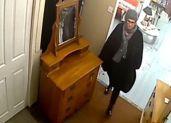 Derbsyhire Policce want to speak to this woman after two bronze statutes were stolen from an antiques shop