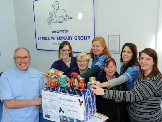 Pictured are Brian Sargeant, the clinical director of Chesterfelds Carrick vets, and some of the staff making their donations. Picture by Anne Shelley.