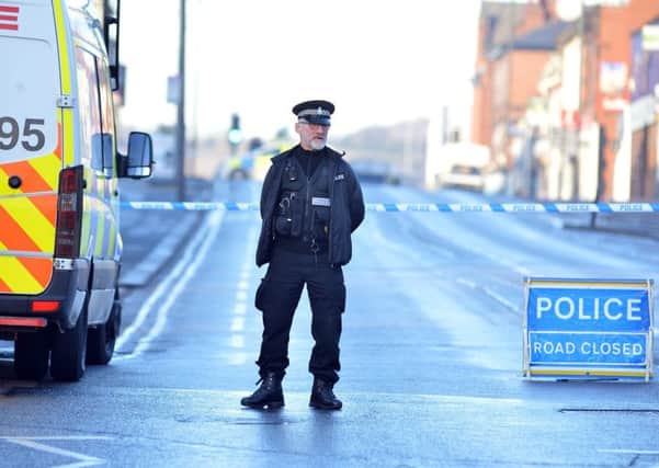 A police officer stands guard on Sheffield Road.