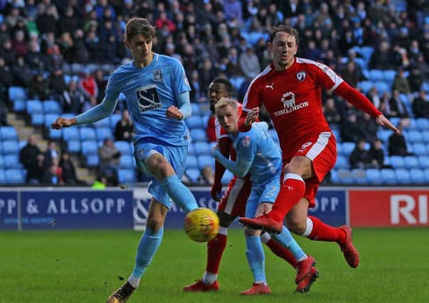 Spireites Kristian Dennis sees his effort blocked by Coventry's Tom Bayliss