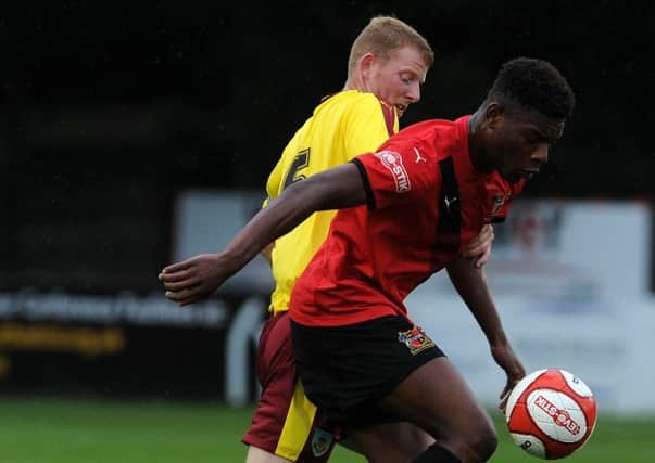 Sheffield FC's Benny Igiehon fends off Burnley's Alex Whitmore. Picture: Andrew Roe