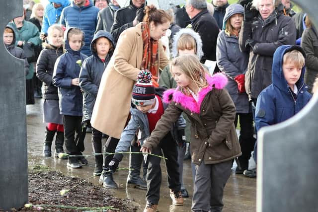 Children from Duckmanton Primary School lay flowers to remember those killed in the 1938 tragedy.