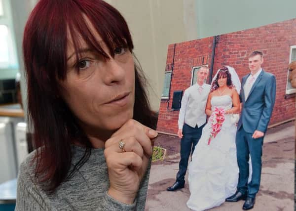 Sharon Whitford holding picture with her son Marc Maltby (white top) who was found dead in Nottingham prison.