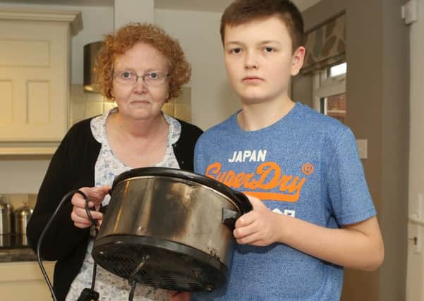 Lindseys son Jacob, 14, with his gran, Anne Ashmore, who put out the fire